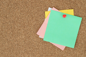 collection of colorful variety post it. paper note reminder sticky notes pin on cork bulletin...