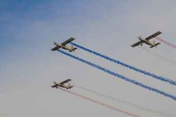 Fototapeta na wymiar Squadron performing air show with coloured smoke releasing