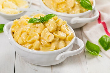 Parmesan Spinach Mac and Cheese on White Wooden Background. Selective focus.