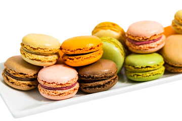 Colorful Macaroons Chocolate, Pistachio, Cherry, Orange, Vanilla Flavor Background Isolated on White Background. Selective focus.
