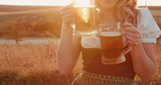 Pretty woman with lush breasts cheers two pints of dark and light beer