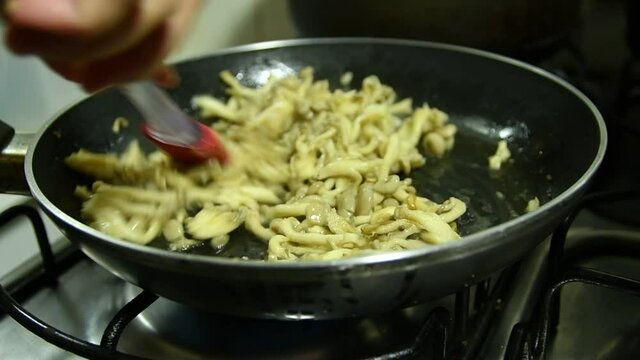 Butter shimeji being prepared in skillet