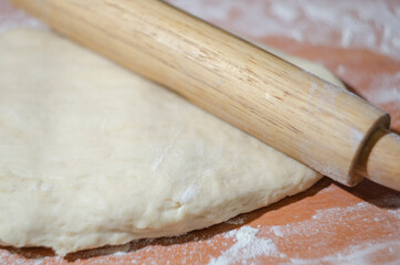 dough and rolling pin on the table