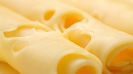 sliced cheese with holes. gold Swiss cheese. macro shot