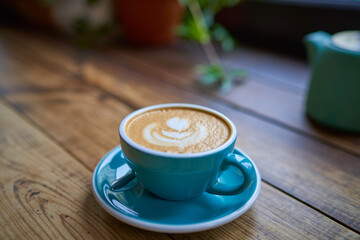 A cup of delicious strong coffee in female hands. Concept drinks, lifestyle, work, background.