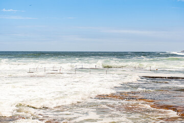 Rock pool at Cronulla, NSW, Australia at high tide following storm weather.