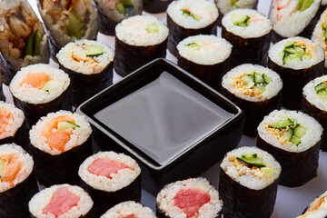 Various kinds of sushi roll set served on cutting board. Japanese food