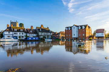 The Abbey Mill, Tewkesbury reflected in flood water from River Avon, with Tewkesbury Abbey in background