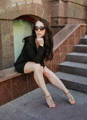 young woman in a black dress with beautiful long legs