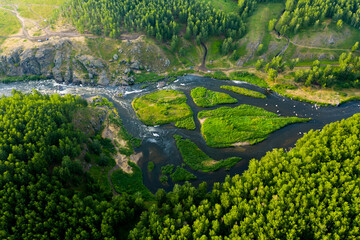 cascade of streams with Islands, green forests and grass, top view from drone, picturesque nature...
