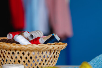Basket full of colorful .spools of thread