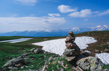 Balancing stones. Balance of stones on the background of snow in the mountains.