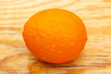 Fresh bright tasty orange on a wooden background, natural vegan food