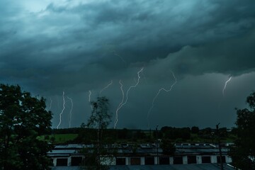 Stormy weather. Bright lightning across the dark sky.