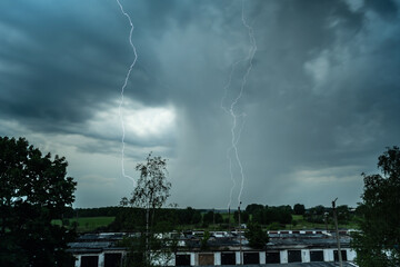 Stormy weather. Bright lightning across the dark sky.