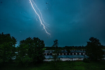 Stormy weather. Bright lightning across the dark sky.