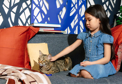 Sweet family moments, little Asian girl with her cat