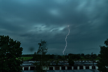 Stormy weather. Bright lightning across the dark sky.