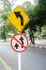 Do not overtake Traffic Sign and traffic signs beware of left curves. Traffic sign board on the winding road.