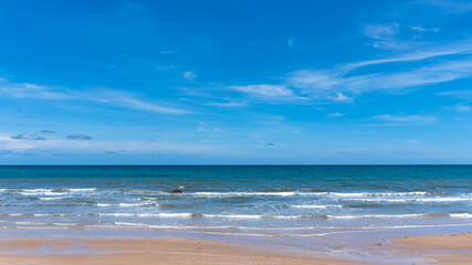 Tropical beach with gentle sea waves and cloudy skies In Chanthaburi province, Thailand, horizon, seascape, sea connect to the sky
