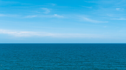 Bright blue sky with white clouds for background or wallpapers.The beauty of tropical nature, Chanthaburi province, Thailand, horizon, seascape, sea connect to the sky

