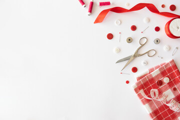 Set of red accessories for tailoring on a white background. Top view with copy space