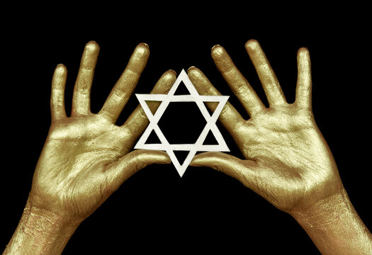 Golden hands on black background with six rays star