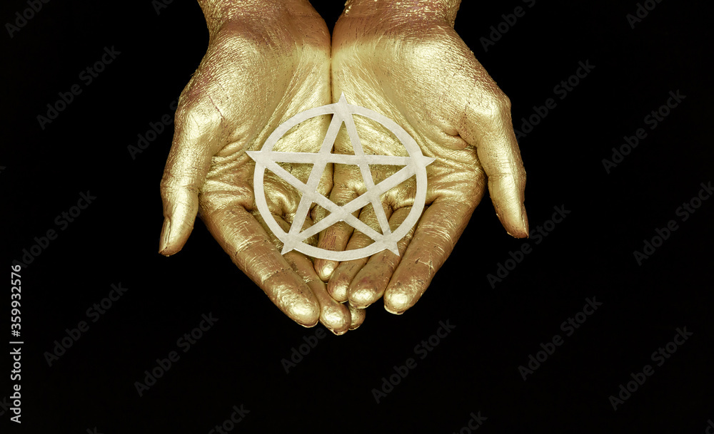 Wall mural golden hands symbol pentacle on black background