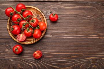 Red ripe cherry tomatoes on wooden table