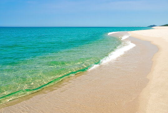 Beautiful coastline with emerald blue green water. Beach landscape with  aquamarine water and white sand.    