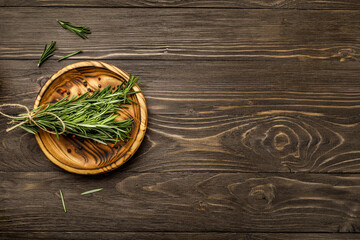 Fresh rosemary sprigs on rustic kitchen table