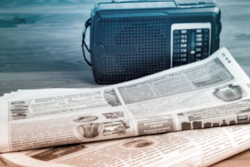 Radio and newspapers on the office desk, media breaking news concept.Soft focus..