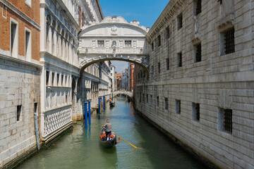 View of the famous bridge of sighs in Venice, italy, with gondola and gondolier on a canal