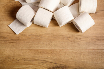 Toilet paper rolls on wooden background
