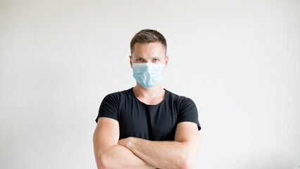 A young man is wearing a protective mask against coronavirus