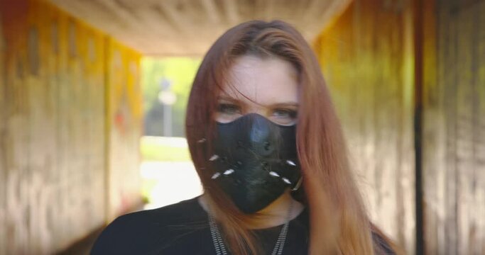 Masked - Young woman is performing a power punch gesture - ProRes