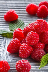 juicy fresh natural raspberries on a gray wooden rustic background