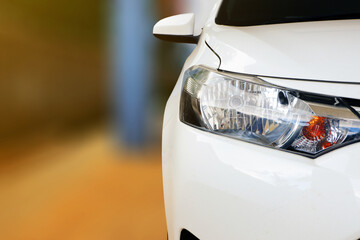 close up of front view of white car When parked at home - obrazy, fototapety, plakaty