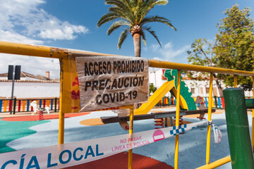 Signs that prohibit the use of a playground during de-escalation due to coronavirus. Posters:...