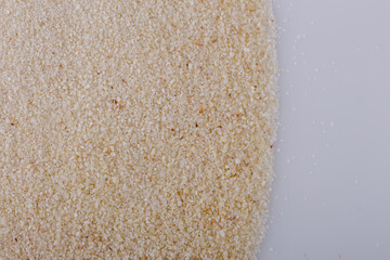 natural organic semolina on white acrylic background