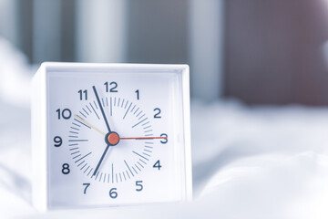 Alarm clock place on a bed