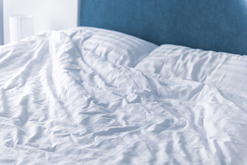 Fototapeta na wymiar Messy bedding sheets and pillow