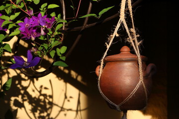 Ceramic pot suspended on the ropes in the garden