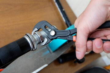 unscrew the nut with an adjustable wrench. repair of household items at home