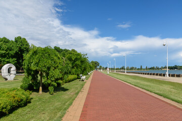 Subotica, Serbia - June 19, 2020: Pedestrian zone next to the Palic lake near the Subotica in Serbia. Palic lake with a beach and promenade  © nedomacki
