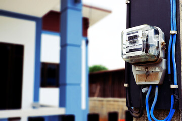 close up electric meter mounted on the front of the new house.