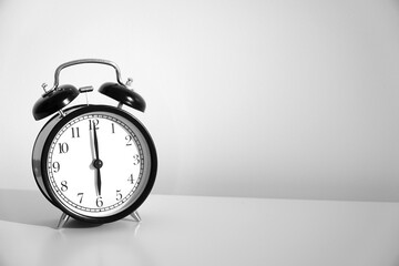 Wake up concept. Close up view of alarm-clock in morning bedroom environment. An image of a retro...