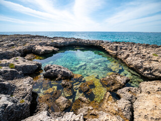 Fototapeta na wymiar natural rock pool on the Ionian coast of Salento Palude del Capitano Nature Reserve, Nardò, Salento, Lecce, Apulia, Italy