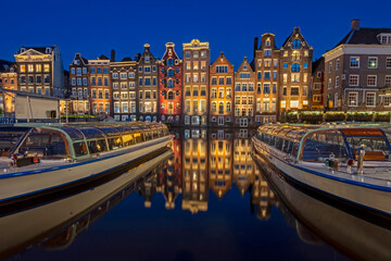 Amsterdam houses along the Damrak in the Netherlands at night