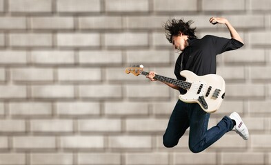 Portrait of a musician man jumps while playing